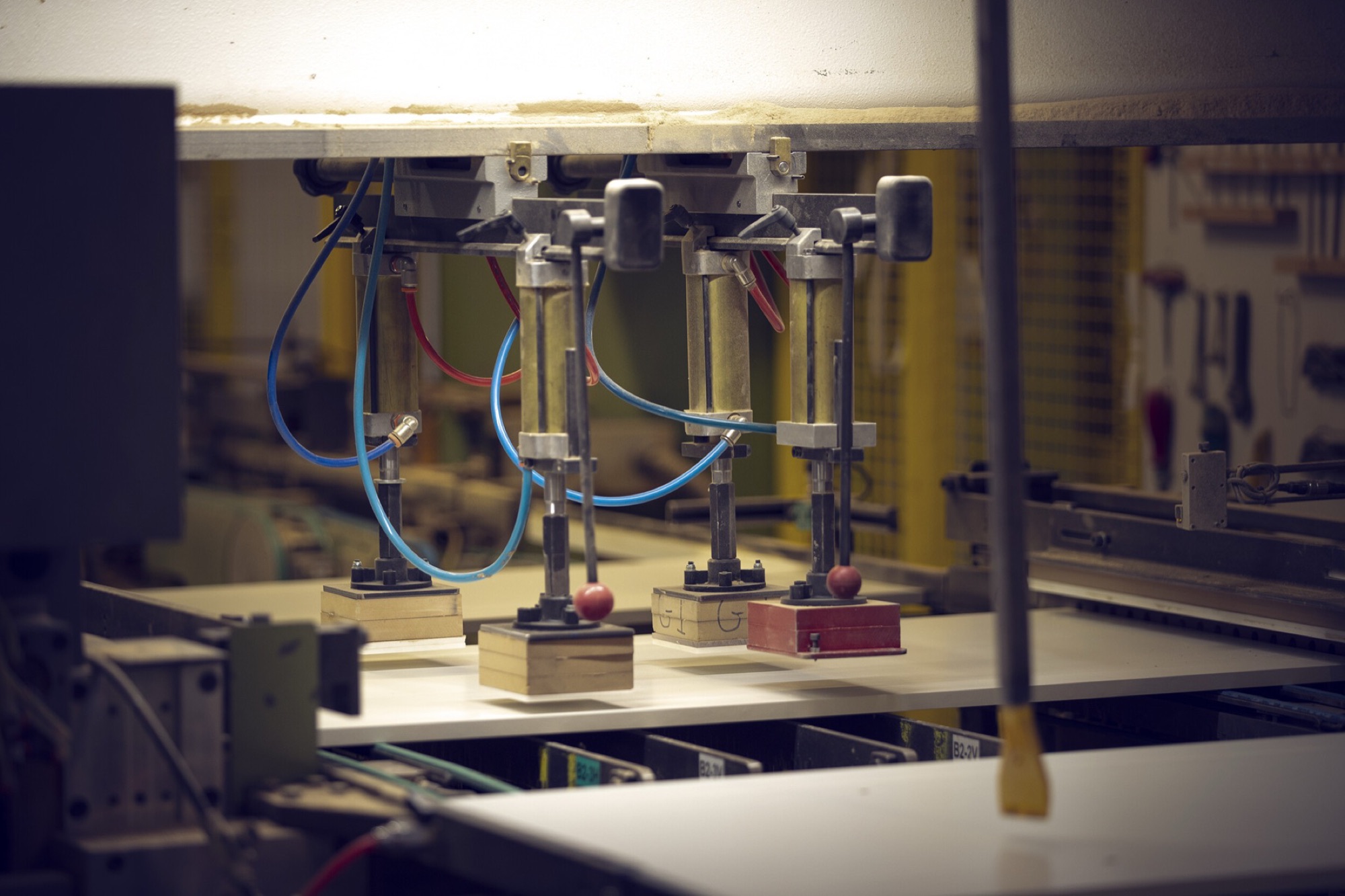 Pneumatic press station on a furniture assembly line